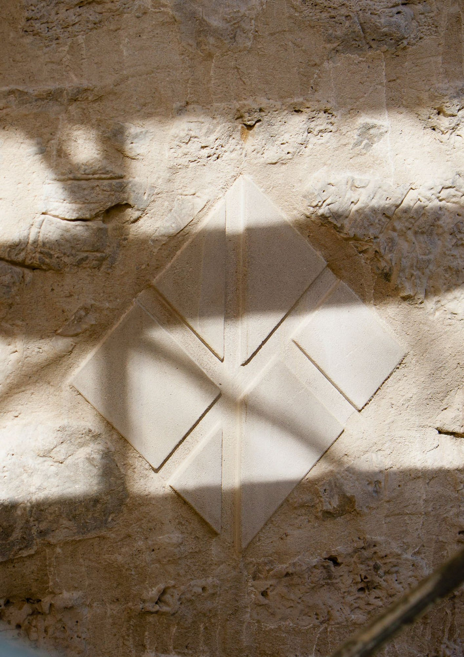 Close-up of craftsmen restoring period details on window frames during the hotel renovation. Kat Florence Monogram in stone.